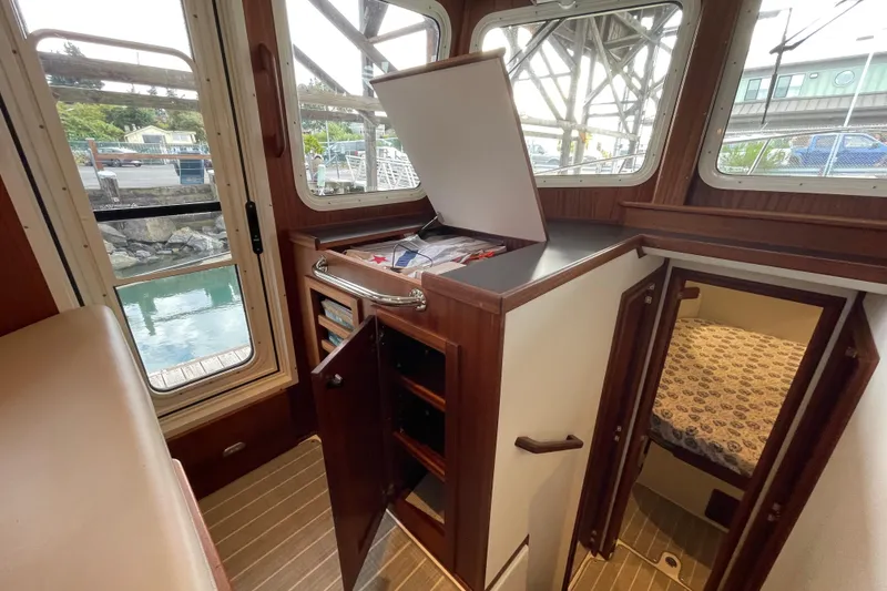 Slide: The Image of Interior of 2022 American Tug 362, featuring wood cabinetry and cozy sleeping quarters. - 20
