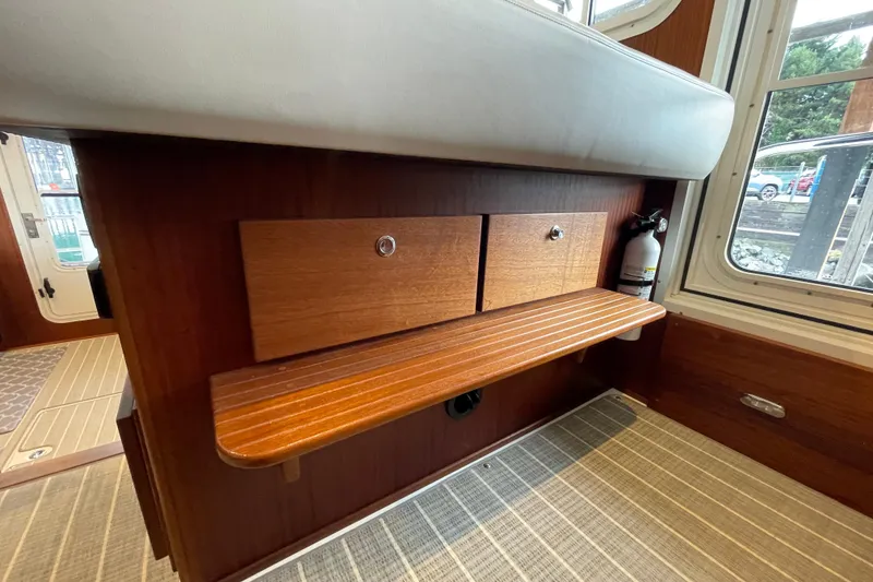 Slide: The Image of Interior of 2022 American Tug 362 with wooden drawers and seating area. - 21