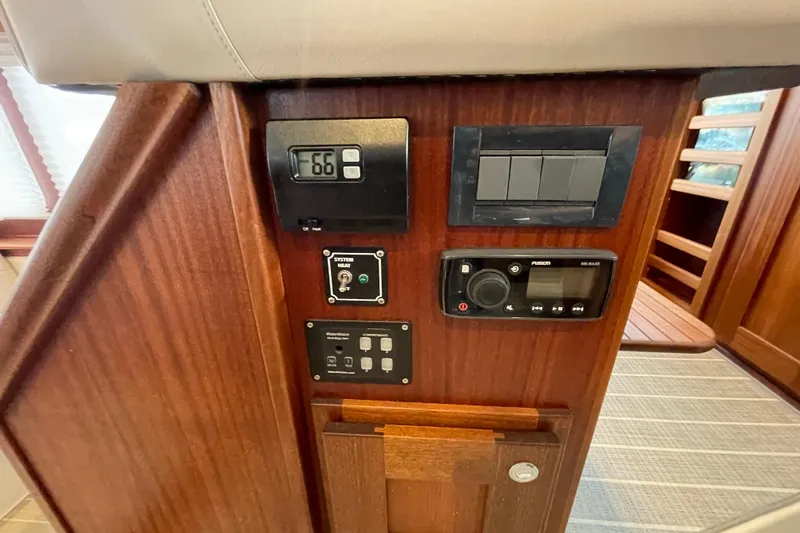 Slide: The Image of Control panel of 2022 American Tug 362 with various switches and displays. - 22