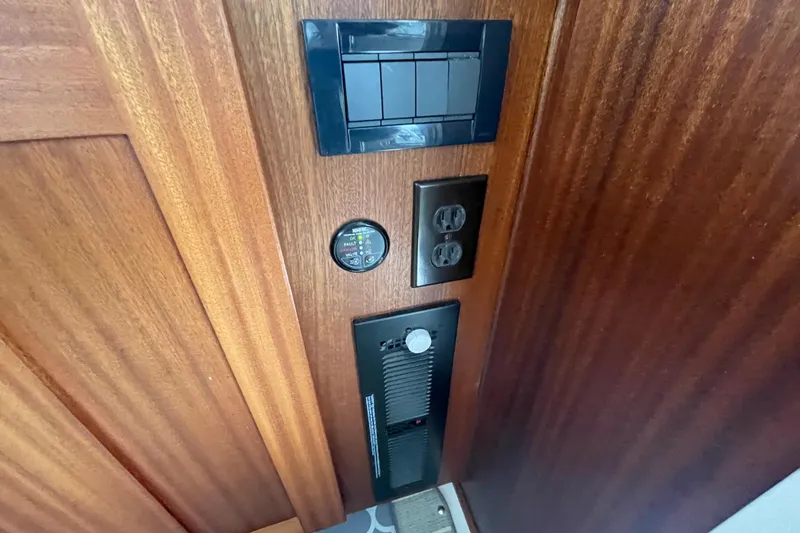 Slide: The Image of Control panel and outlets on 2022 American Tug 362 wooden interior. - 23