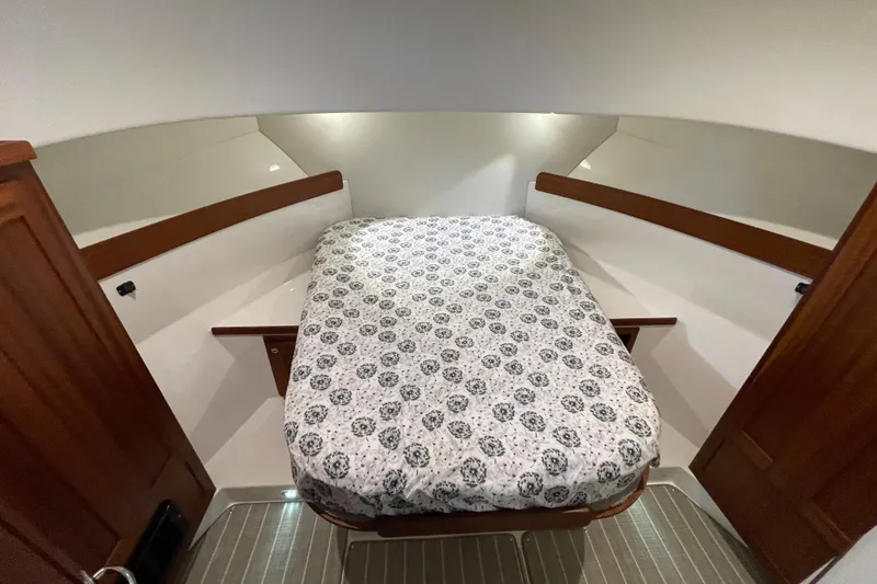 Slide: The Image of Cozy cabin interior of 2022 American Tug 362 with patterned bedding and wooden accents. - 31