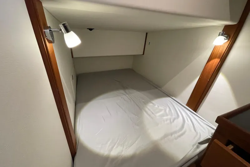 Slide: The Image of Cozy cabin interior of 2022 American Tug 362 with soft lighting and comfortable bedding. - 40