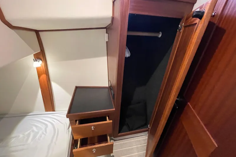 Slide: The Image of 2022 American Tug 362 cabin interior with open wardrobe and drawers. - 42