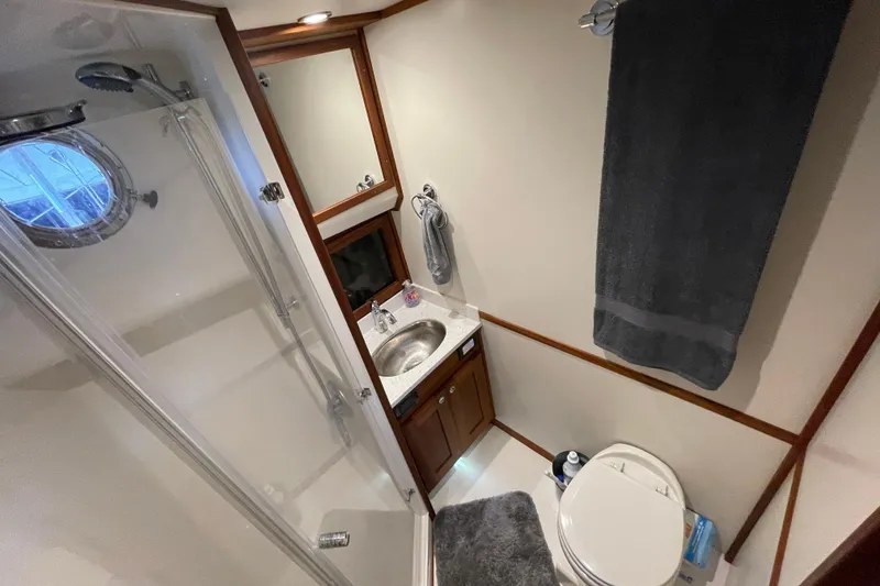 Slide: The Image of Modern bathroom in 2022 American Tug 362 with shower, sink, and toilet. - 46