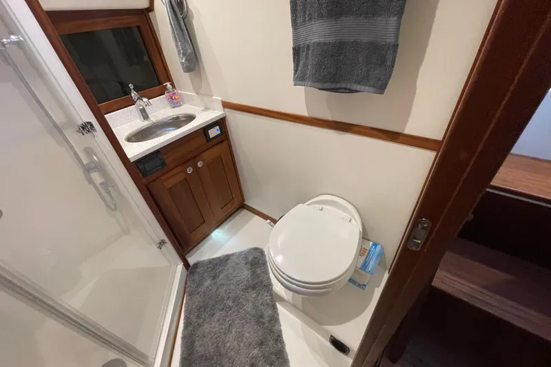 Slide: The Image of Bathroom interior of 2022 American Tug 362 with sink, toilet, and shower. - 47
