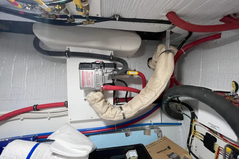 Slide: The Image of Engine room of 2022 American Tug 362 with insulated pipes and wiring. - 53