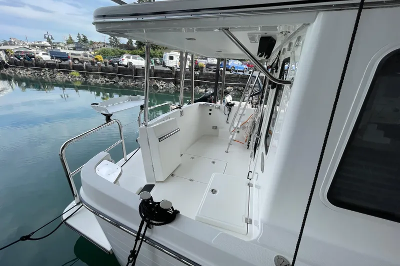 Slide: The Image of 2022 American Tug 362 boat deck with marina view, showcasing sleek design and spacious layout. - 57