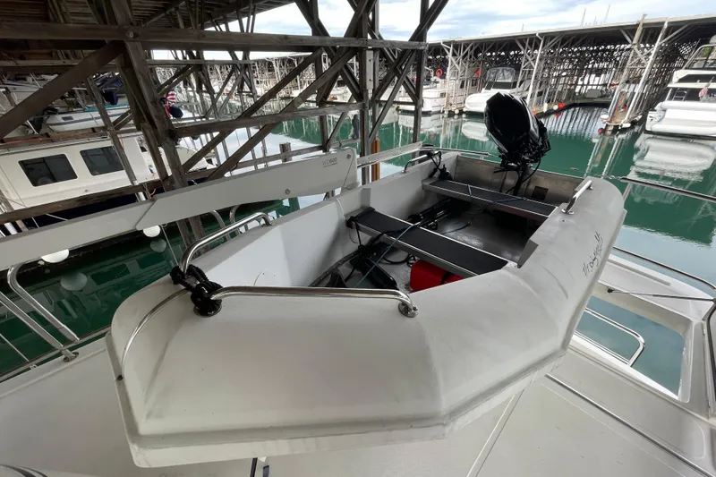 Slide: The Image of American Tug 362 (2022) docked, featuring a small motorboat on deck. - 58