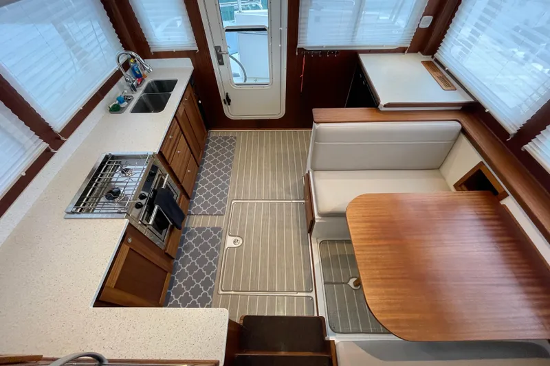 Slide: The Image of Interior of 2022 American Tug 362 featuring kitchen and dining area with modern amenities. - 8