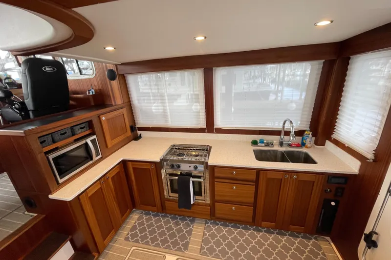 Slide: The Image of Modern kitchen interior of 2022 American Tug 362 with wood cabinetry and stainless steel appliances. - 9