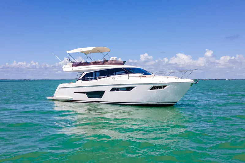 The Image of 2022 Ferretti Yachts 500 cruising on clear blue waters under a sunny sky. - 0