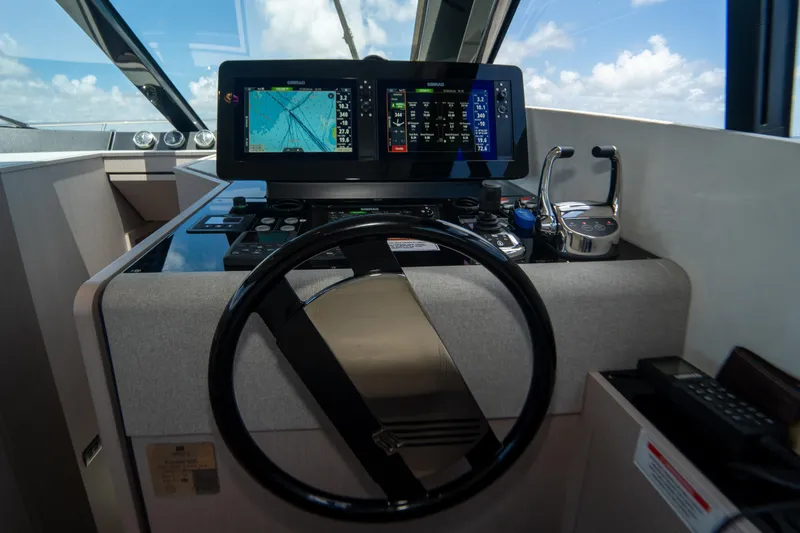 Slide: The Image of Helm of 2022 Ferretti Yachts 500 with navigation screens and controls. - 29