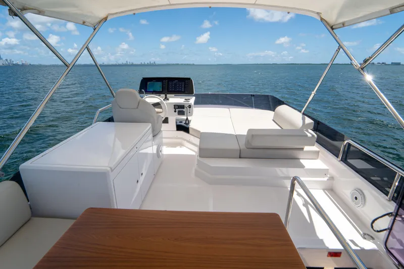 Slide: The Image of Luxurious 2022 Ferretti Yachts 500 flybridge with seating, helm, and ocean view. - 48