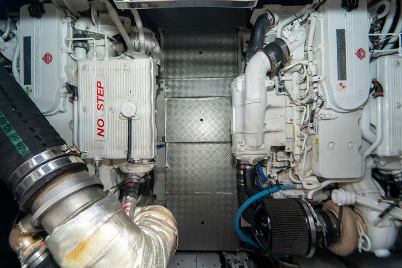 Slide: The Image of Engine room of 2022 Ferretti Yachts 500, featuring dual engines and "No Step" warning. - 53