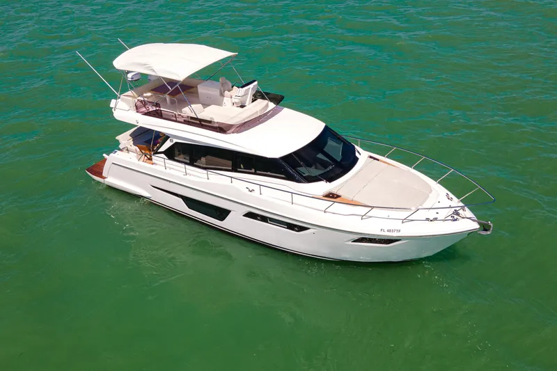 Slide: The Image of 2022 Ferretti Yachts 500 cruising on clear turquoise waters. - 19