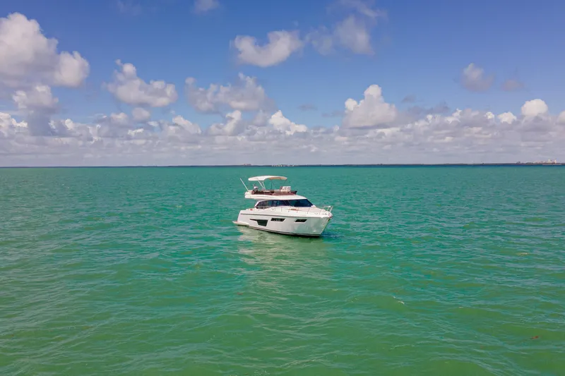 Slide: The Image of 2022 Ferretti Yachts 500 cruising on turquoise ocean under blue sky. - 20