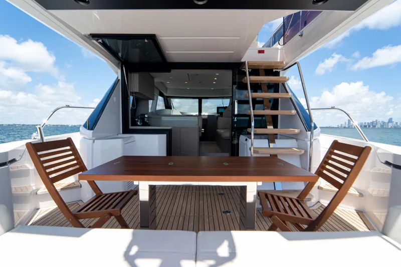 Slide: The Image of Luxurious 2022 Ferretti Yachts 500 deck with wooden table and chairs, ocean view. - 21