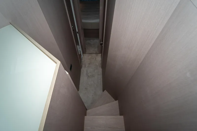 Slide: The Image of Staircase inside 2022 Ferretti Yachts 500, featuring modern wood paneling and sleek design. - 32