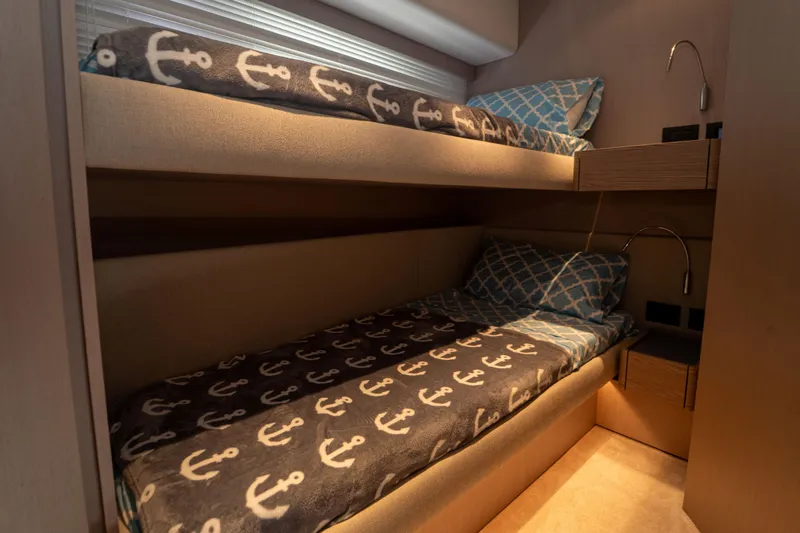 Slide: The Image of Bunk beds in 2022 Ferretti Yachts 500 cabin with nautical-themed bedding. - 38