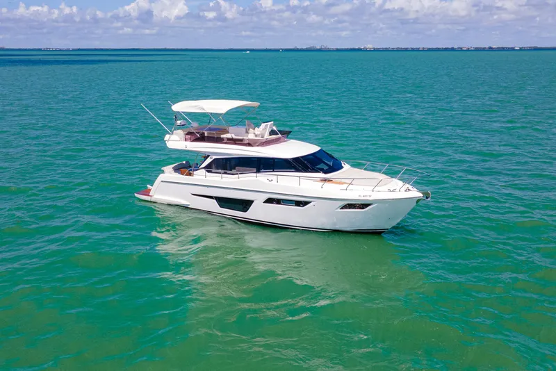 Slide: The Image of 2022 Ferretti Yachts 500 cruising on turquoise waters under a clear sky. - 9