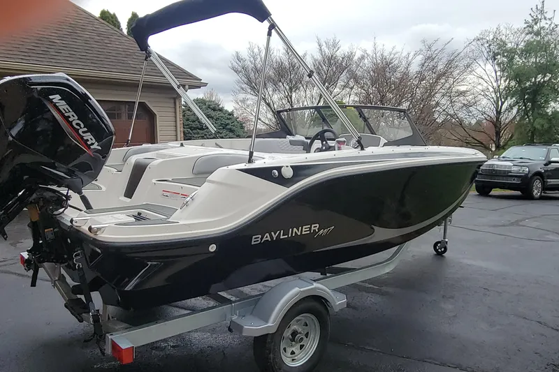 Slide: The Image of 2025 Bayliner Element M17 boat on trailer with Mercury engine in driveway. - 3