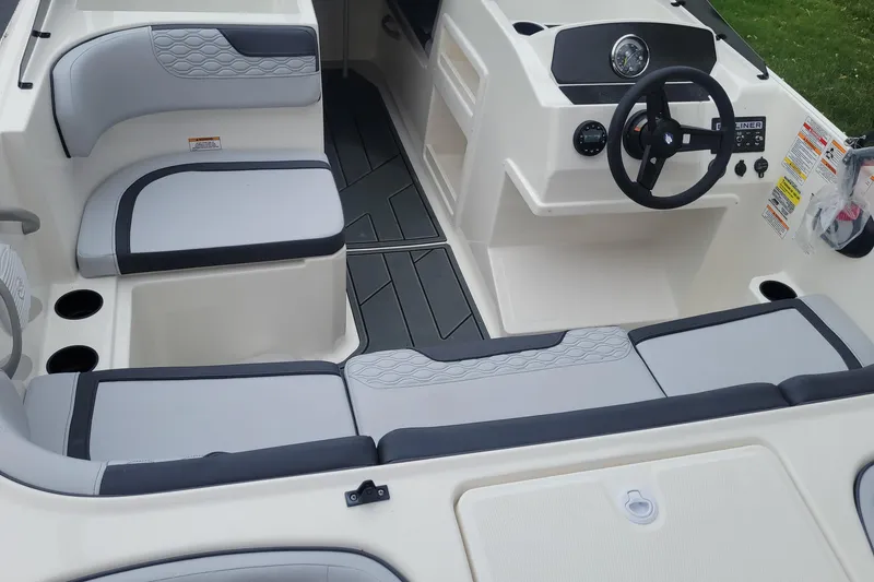 Slide: The Image of 2025 Bayliner Element M17 boat interior with modern seating and steering console. - 6