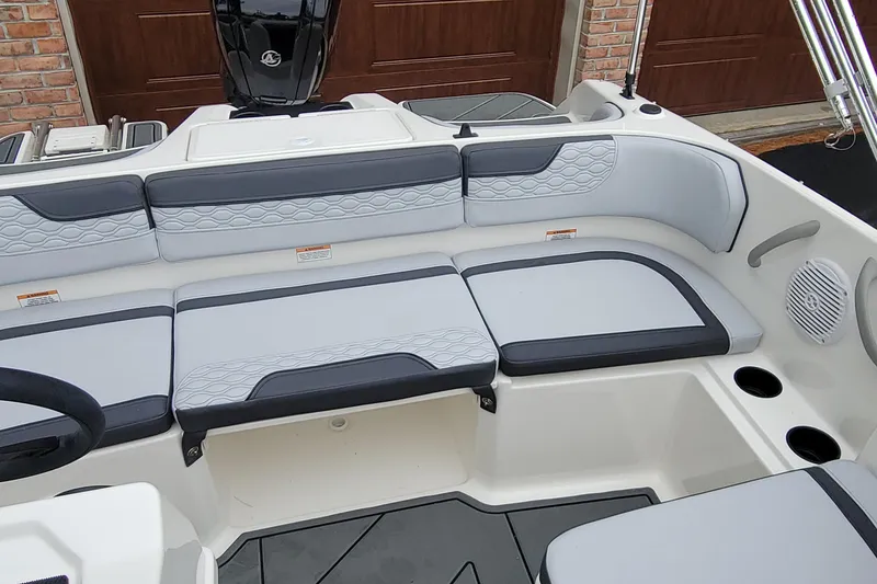 Slide: The Image of 2025 Bayliner Element M17 boat interior with gray cushioned seating and cup holders. - 8