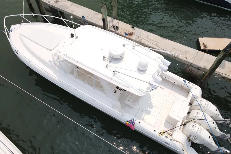 Slide: The Image of 2010 Intrepid 390 Sport Yacht docked, aerial view showcasing sleek design and triple engines. - 15