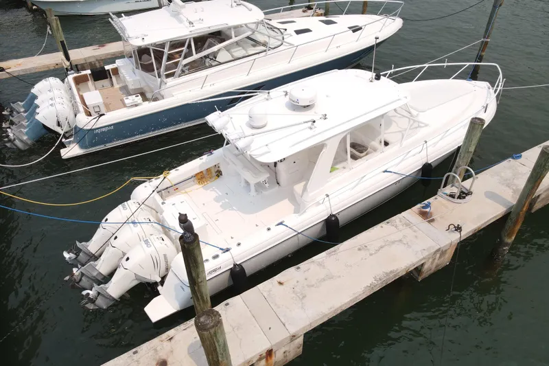 Slide: The Image of 2010 Intrepid 390 Sport Yacht docked with triple outboard engines. - 21
