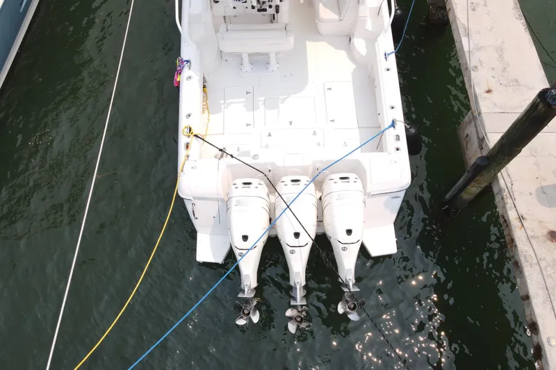 Slide: The Image of Overhead view of a 2010 Intrepid 390 Sport Yacht docked with triple outboard engines. - 22