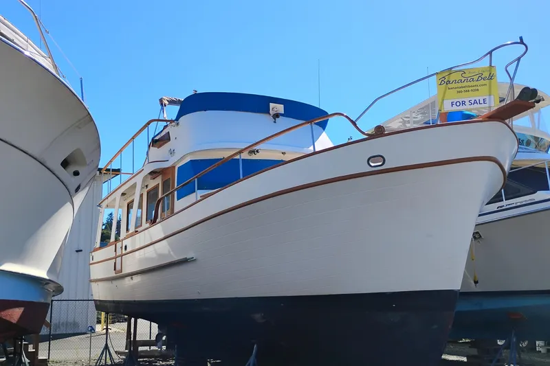 Slide: The Image of 1978 Puget 38 Europa Trawler for sale, docked under clear blue sky. - 1