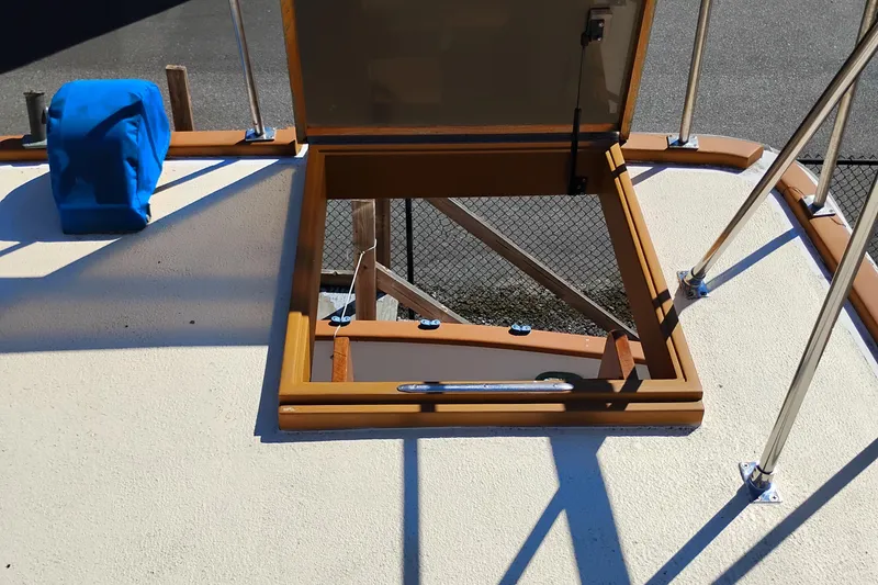 Slide: The Image of Open hatch on 1978 Puget 38 Europa Trawler deck with blue cover nearby. - 13