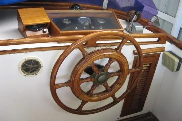 Slide: The Image of 1978 Puget 38 Europa Trawler helm with wooden wheel and control panel. - 21