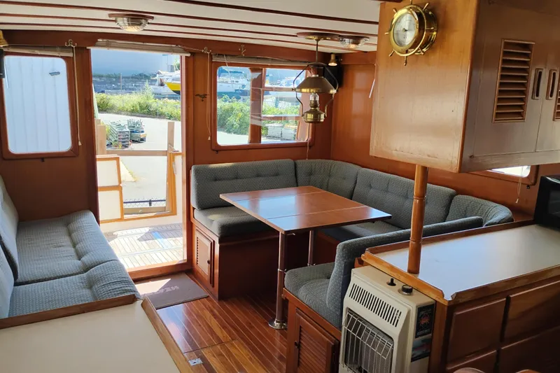 Slide: The Image of Interior of 1978 Puget 38 Europa Trawler with cozy seating and wooden accents. - 23