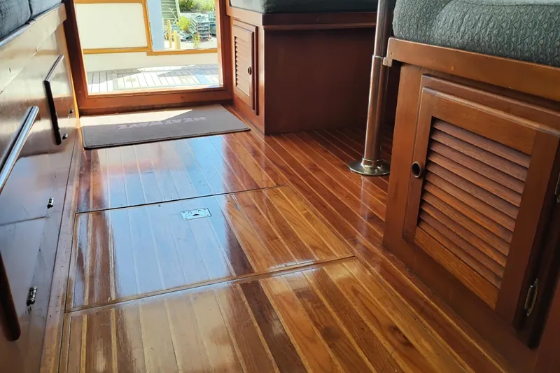 Slide: The Image of Interior of 1978 Puget 38 Europa Trawler with polished wooden flooring and cabinetry. - 28