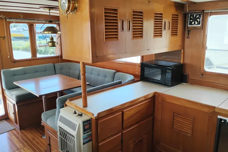 Slide: The Image of Interior of 1978 Puget 38 Europa Trawler with wood cabinetry and cozy dining area. - 30