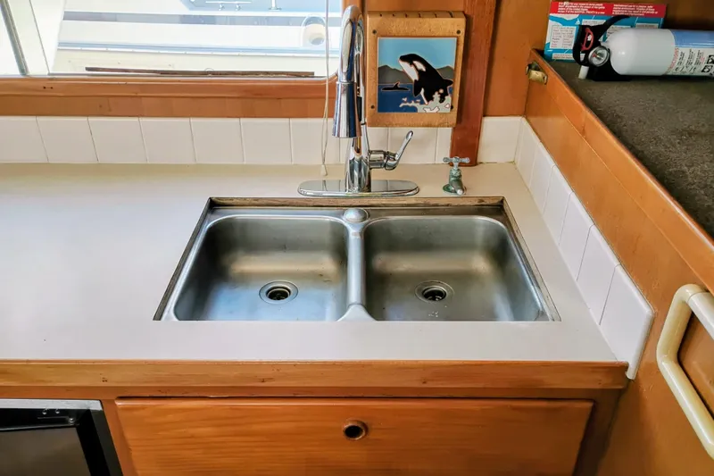 Slide: The Image of 1978 Puget 38 Europa Trawler kitchen sink with dual basins and modern faucet. - 32