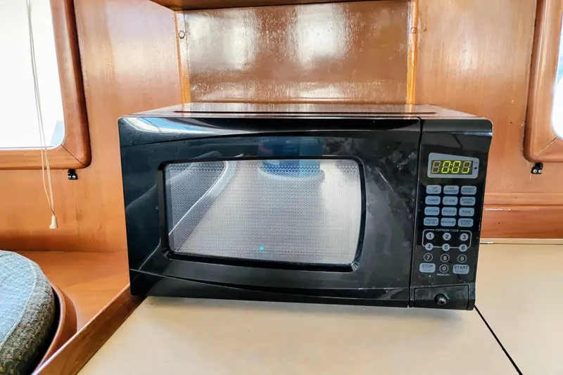 Slide: The Image of Microwave inside 1978 Puget 38 Europa Trawler, wooden interior, digital display. - 33