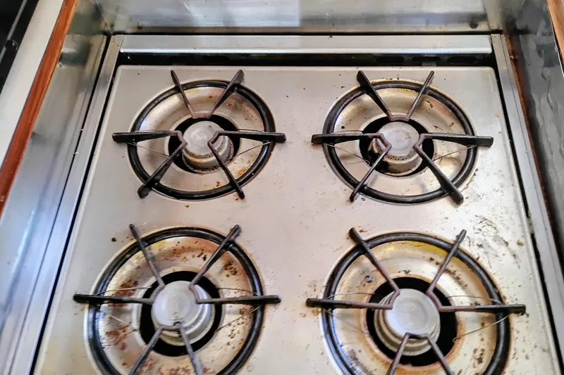 Slide: The Image of Four-burner stove on 1978 Puget 38 Europa Trawler, showing signs of use. - 35