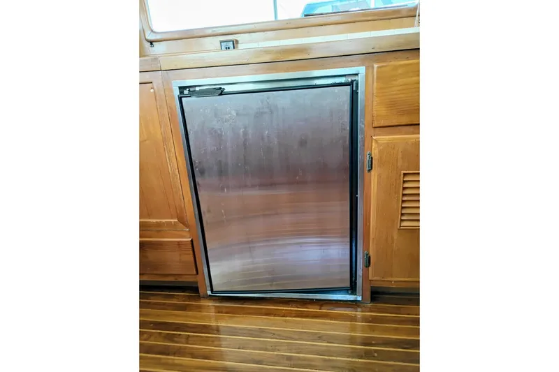 Slide: The Image of Stainless steel refrigerator in 1978 Puget 38 Europa Trawler's wooden interior. - 36