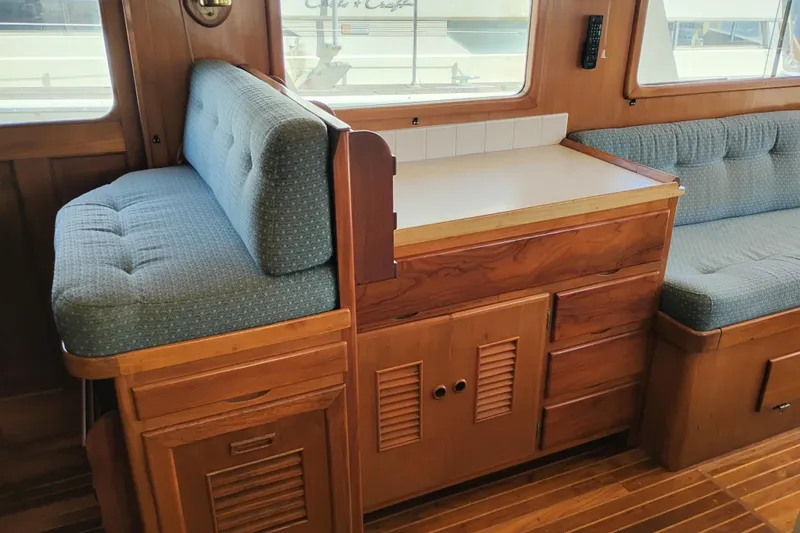 Slide: The Image of 1978 Puget 38 Europa Trawler interior with wooden cabinetry and cushioned seating. - 37