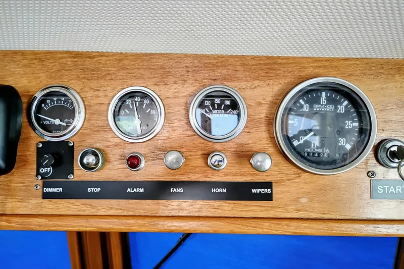 Slide: The Image of 1978 Puget 38 Europa Trawler dashboard with gauges and control switches. - 39