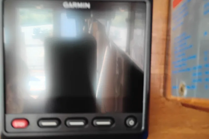 Slide: The Image of Garmin device on 1978 Puget 38 Europa Trawler dashboard, reflecting interior. - 40