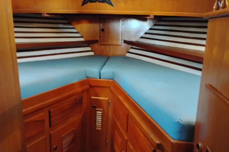 Slide: The Image of 1978 Puget 38 Europa Trawler cabin with blue cushions and wooden interior. - 45
