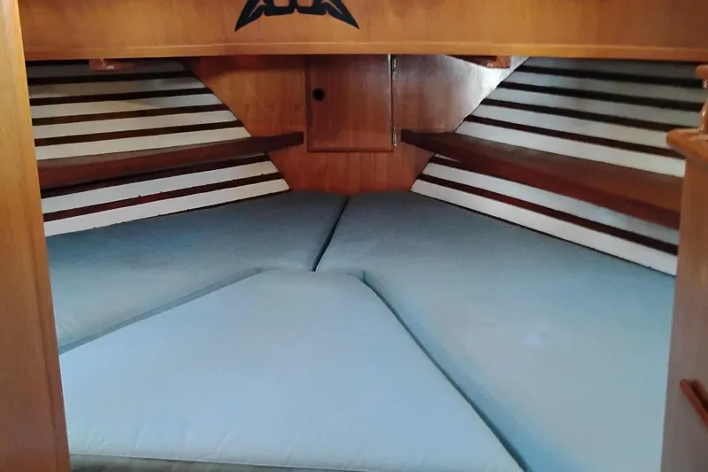 Slide: The Image of Cozy cabin interior of 1978 Puget 38 Europa Trawler with blue cushions and wooden accents. - 46
