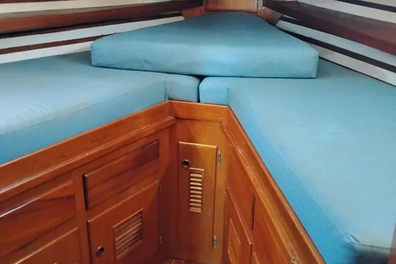 Slide: The Image of 1978 Puget 38 Europa Trawler interior with blue cushions and wooden cabinetry. - 47