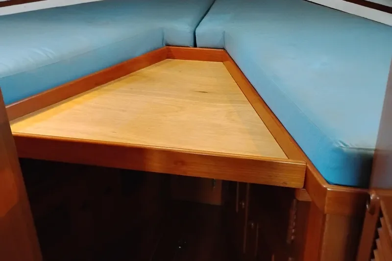 Slide: The Image of Interior of 1978 Puget 38 Europa Trawler with blue cushions and wooden surfaces. - 48