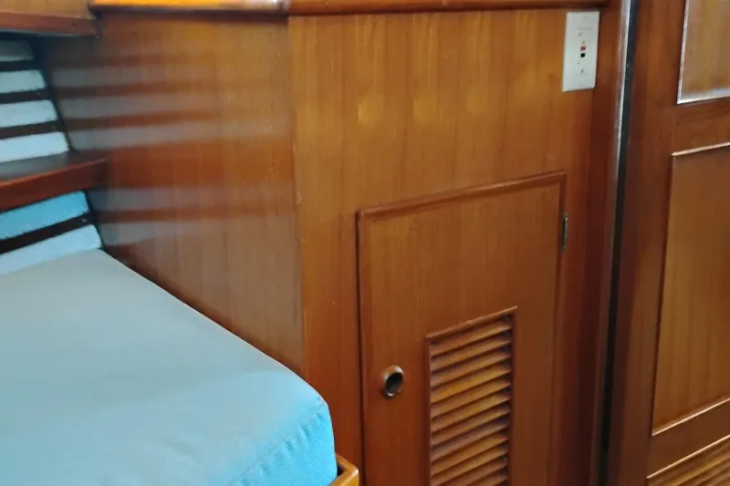 Slide: The Image of Interior of 1978 Puget 38 Europa Trawler with wooden paneling and blue seating. - 49