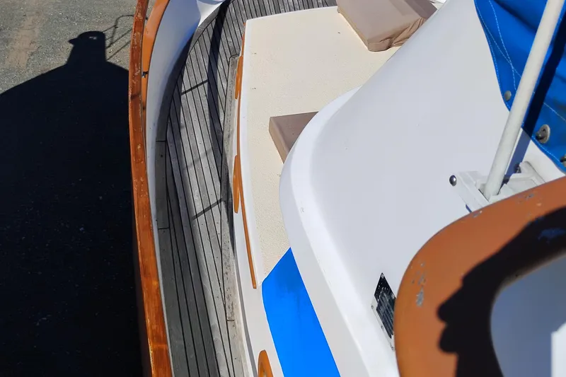 Slide: The Image of 1978 Puget 38 Europa Trawler deck with wooden railings and blue accents. - 5