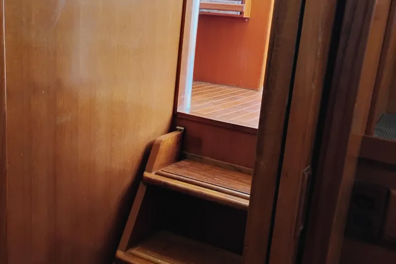 Slide: The Image of Wooden interior stairs on a 1978 Puget 38 Europa Trawler boat. - 52